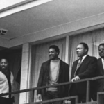 Jesse Jackson standing with Martin Luther King Jr. on the balcony of the Lorraine Motel