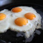 In the hallowed halls of institutions like the Culinary Institute of America or Le Cordon Bleu, the humble egg is not merely a breakfast staple; it is a rigorous litmus test of a chef’s discipline, patience, and technical precision. While the home cook often views the frying pan as a theater of high-heat speed, the professional kitchen treats it as a laboratory of thermal control. Our analysis shows that the gap between a rubbery, sulfurous scramble and a Michelin-starred omelet lies not in the quality of the poultry, but in a series of highly guarded procedural nuances that prioritize texture over velocity. Visual: professional chef cooking elegant French omelet in a high-end kitchen Photo by Pexels via Pixabay The foundational error in domestic egg preparation is an over-reliance on aggressive BTUs. Industry data suggests that the chemical structure of egg proteins—specifically the delicate balance of globulins and ovomucoid—reacts poorly to rapid temperature spikes. When subjected to high heat, these proteins tighten into a dense, hydrophobic matrix, squeezing out moisture and resulting in the dreaded "weeping" effect. Professional pedagogy dictates a "low and slow" approach. By maintaining a gentle thermal environment, the proteins denature slowly, allowing for a soft, custard-like coagulation that preserves the inherent creaminess of the yolk. This method requires a psychological shift for the cook, moving away from the sear and toward a meditative, controlled simmer. The Thermodynamic Paradox of the Perfect Scramble To achieve the silken consistency lauded by critics at Michelin, the choice of equipment is as vital as the heat source. The transition from cast iron or stainless steel to high-quality non-stick surfaces represents a strategic evolution in the professional kitchen. A pristine non-stick surface allows the egg to glide rather than bond, preventing the tearing of the delicate curd. This structural integrity is further supported by the use of a thin, flexible silicone spatula. Unlike rigid metal or wooden variants, a flexible tool can navigate the contours of the pan, ensuring that no pocket of egg is left to overcook against the heated perimeter. YOUTUBE REFERENCE Recommended Video Topic: French omelet technique masterclass Beyond the pan, the secret to a uniform, vibrant finish often begins before the egg even touches the heat. Our analysis of high-end gastronomic workflows reveals that many top-tier chefs insist on straining or blending the eggs prior to cooking. This is not a mere aesthetic choice; it is a mechanical necessity for homogeneity. By breaking down the chalazae—the thick, ropey strands of protein that hold the yolk in place—and passing the mixture through a fine-mesh sieve, the chef ensures a consistent texture that is devoid of white streaks or uneven lumps. This creates a monochromatic, velvet-like canvas that is the hallmark of professional-grade execution. The Molecular Approach to Homogeneity and Agitation Once the eggs are in the pan, the technique shifts to constant kinetic energy. In the world of elite gastronomy, as often highlighted by Eater, the "set it and forget it" mentality is non-existent. Constant agitation is the key to preventing large, dry curds from forming. By mimicking the motion of a whisk or using small, circular movements with a spatula, the chef breaks down the coagulating proteins into microscopic fragments. This results in a "small curd" scramble, which possesses a mouthfeel more akin to a rich sauce than a solid food. Visual: close up of creamy soft scrambled eggs with chives on a designer plate Photo by MAKY_OREL via Pixabay This level of attention extends to the precise moment the pan is removed from the flame. One of the most critical "secrets" taught in culinary schools is the mastery of carry-over cooking. Eggs are notoriously sensitive to residual heat; even after being plated, the internal temperature continues to rise. Based on industry data, a chef who waits until the eggs look "done" in the pan has already overcooked them. The professional standard is to remove the eggs when they appear slightly underdone—glistening and almost liquid—allowing the ambient heat to finalize the texture during the walk from the stove to the pass. Future Outlook: The Evolution of the Classic Omelet As we look toward the future of breakfast gastronomy, the influence of these classic techniques remains unshakable, even as technology like precision induction burners and sous-vide immersion circulators enters the fray. The core principles of moisture retention and protein management continue to define the "Gold Standard" as recognized by publications like Bon Appétit and Food & Wine. While home trends may lean toward the convenience of air fryers or rapid-boil gadgets, the professional world remains committed to the manual mastery of the flame. The "Shocking Masterclass" revealed here is not about a secret ingredient, but about a profound respect for the ingredient's biology. Mastering these six techniques—low heat, non-stick precision, flexible tools, homogeneity, constant agitation, and the strategic early pull—allows any cook to transcend the mundane and enter the realm of true culinary artistry. The egg, in its simplicity, remains the ultimate canvas for those who understand that in the kitchen, patience is the most powerful tool of all.