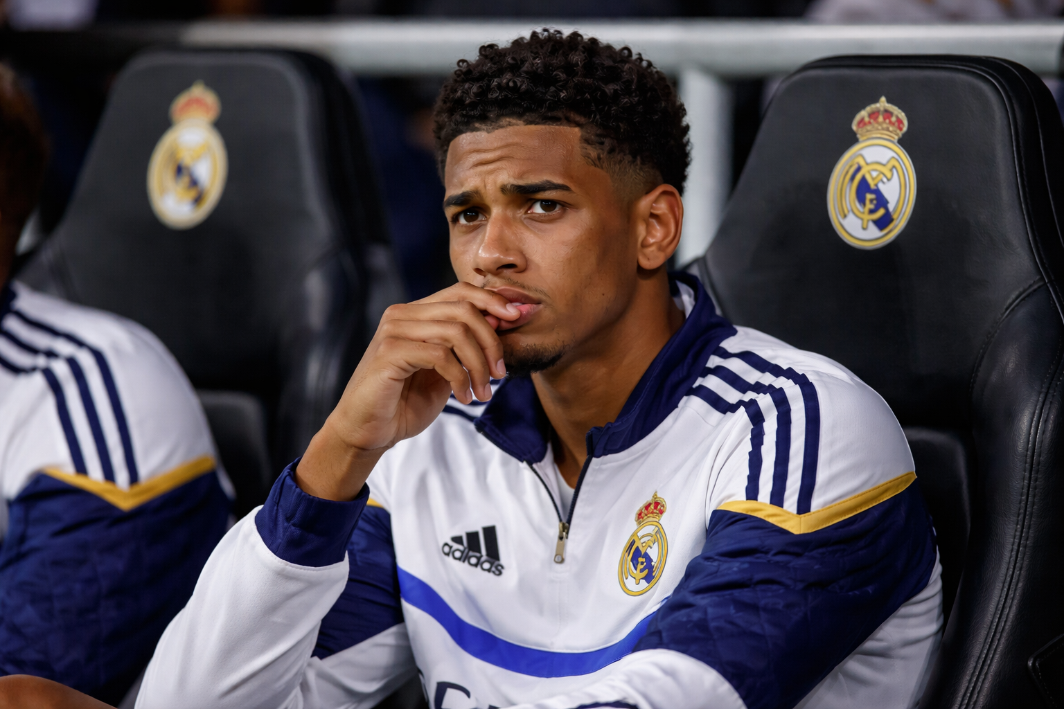 Jude Bellingham looking frustrated on the bench during a Real Madrid match
