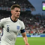 Ben White during the England vs Uruguay match, showing a focused expression amidst the stadium atmosphere