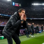 Hansi Flick shouting instructions from the Barcelona touchline during a night match at the Camp Nou