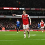 Martin Ødegaard directing play during a high-stakes Premier League match