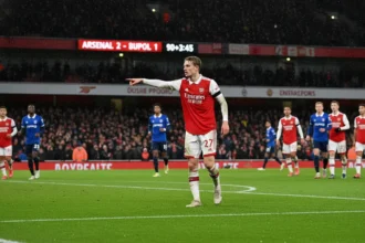 Martin Ødegaard directing play during a high-stakes Premier League match