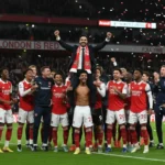 Mikel Arteta celebrating with the Arsenal squad after the final whistle against Newcastle United.