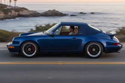 Side profile of the Singer Porsche 911 Carrera Cabriolet in Pacific Blue with the Z-fold roof stowed.