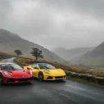 The Noble M500 and Lotus Emira parked side-by-side on a misty Welsh mountain road